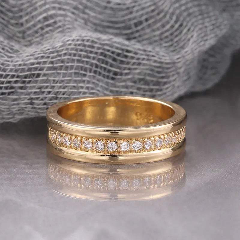 Gold-plated copper geometric ring with inlaid zircon on white background