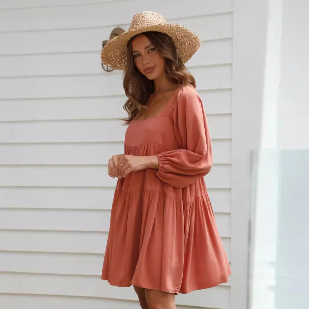 Orange backless A-line dress for a girl with a square collar and puff sleeves.