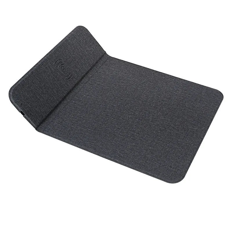 Black 2-in-1 wireless charging mouse pad on a desk with a phone resting on the built-in bracket