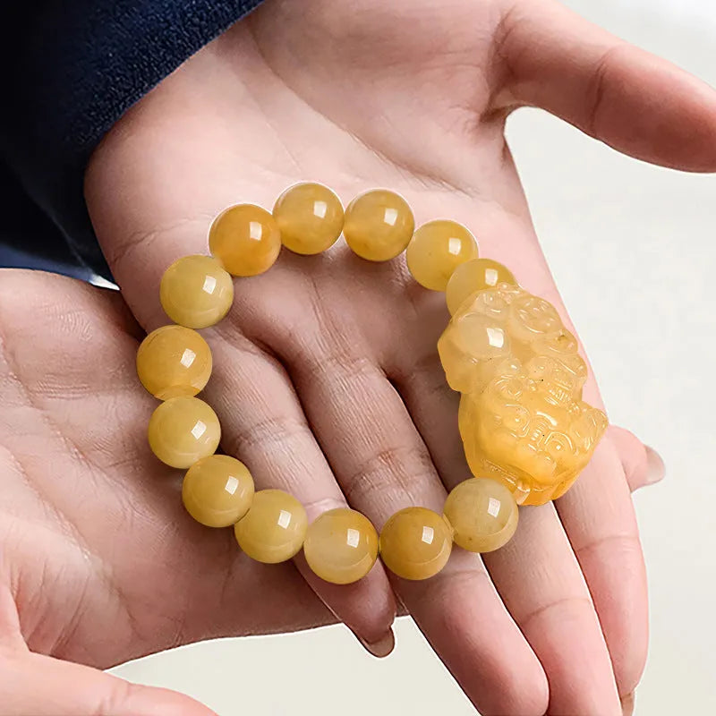 Golden Thread Jinsi Jade bracelet with a carved fortune coin and round jade beads in two size options.