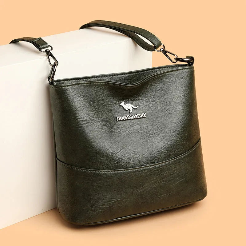 Women's PU leather crossbody bucket bag with wide strap, outer slit pocket, and internal phone and file pockets.