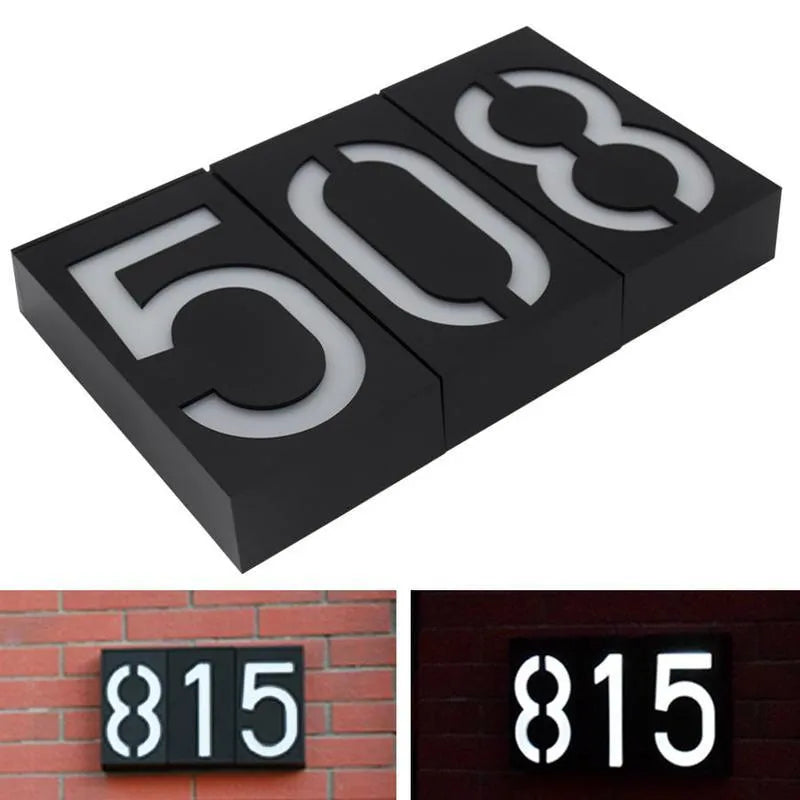 White solar-powered outdoor house number light with visible solar panel and LEDs.