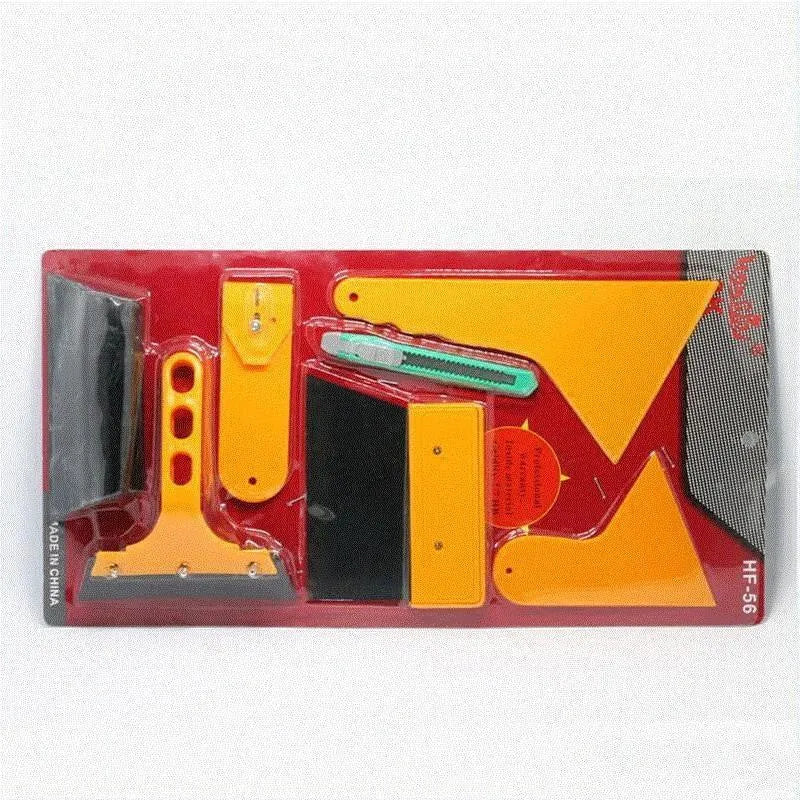 Seven-piece car film tool set including scrapers, knives, and a pressing block on a work surface.