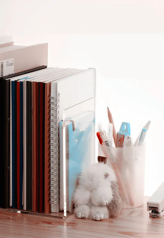 Transparent acrylic bookshelf display rack holding a pair of books on a desk