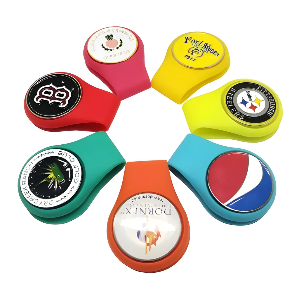 Silicone golf hat clip ball marker holder in bright colours, clipped to a hat and holding a metal ball marker
