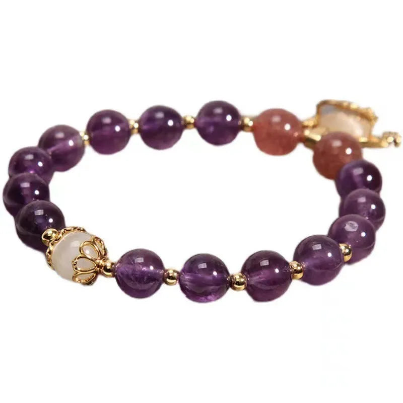 Close-up of a handmade copper bracelet for women with a drop-shaped longevity lock charm, Ruyi element, amethyst stones, and gold accents.