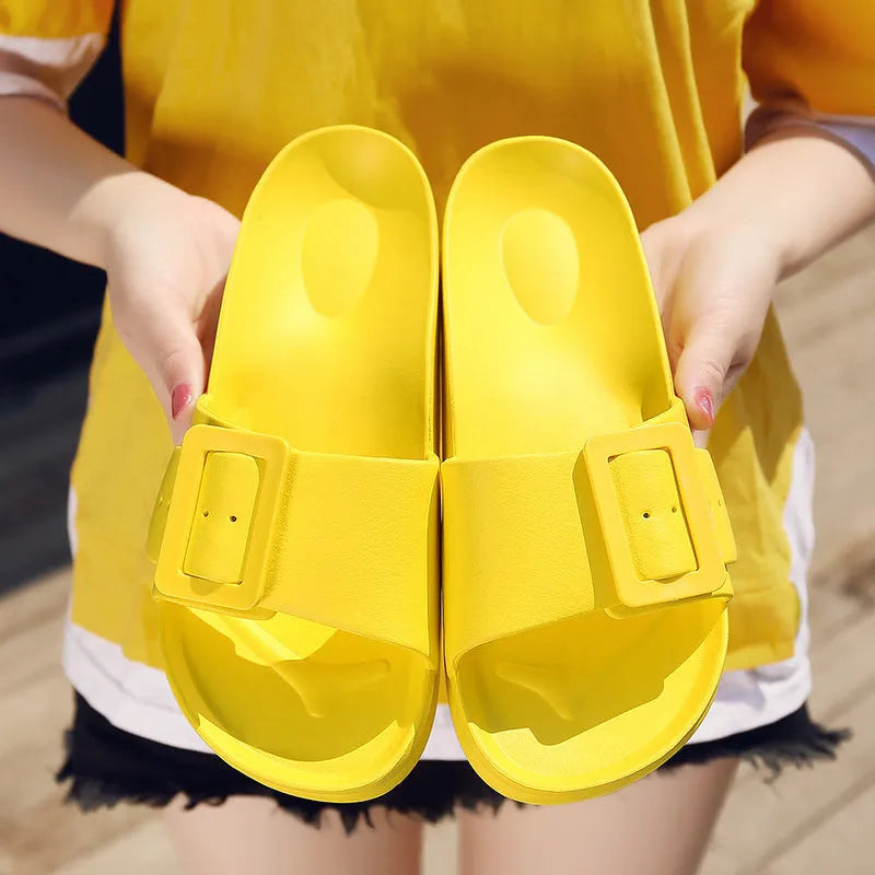 Women's grey blue flip-flop slippers with a buckle strap and soft EVA sole on a light background.