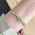 Green copper bracelet with ethnic peace buckle design and jade double ring strap