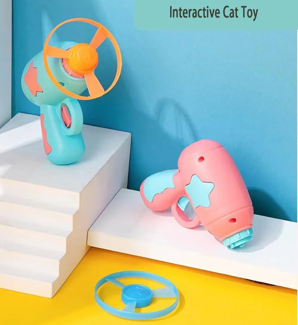 Blue plastic cat toy gun with spinning Frisbee ready for launch