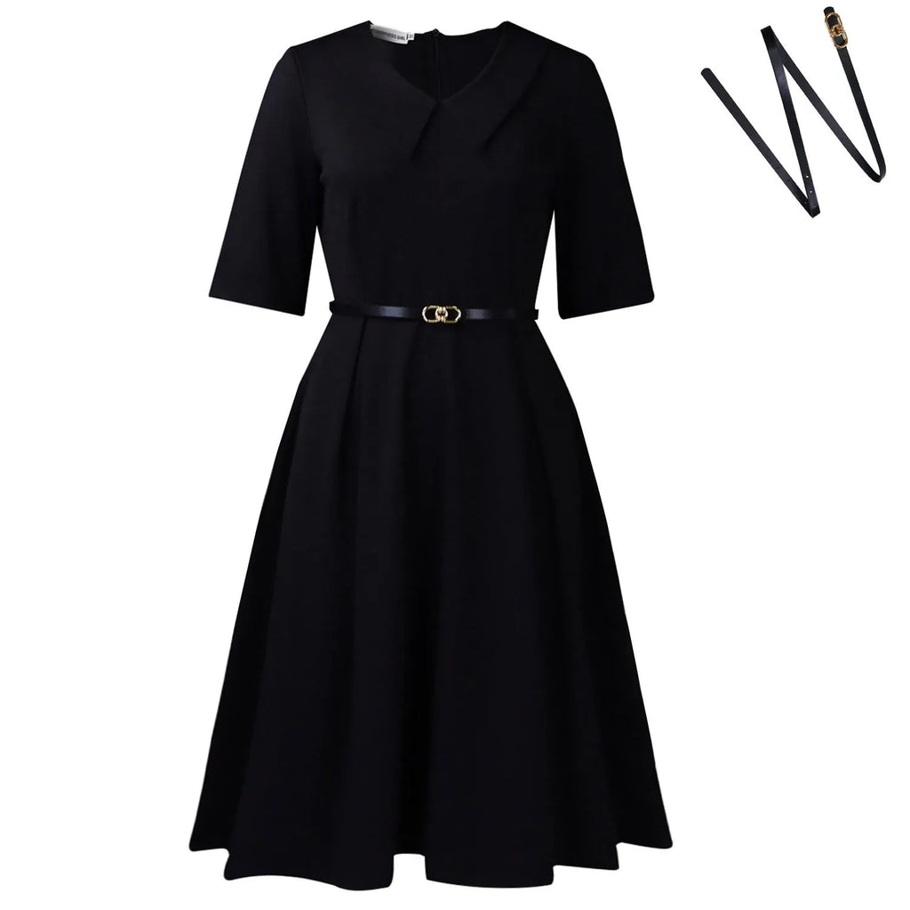A woman wearing a solid colour African dress with half sleeves and a high waist, featuring a contrasting coloured belt.