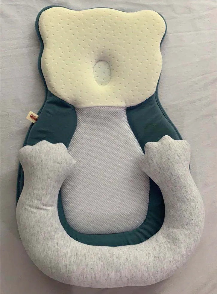 Folded portable baby travel bed with a soft beige cotton sleep cushion for newborns