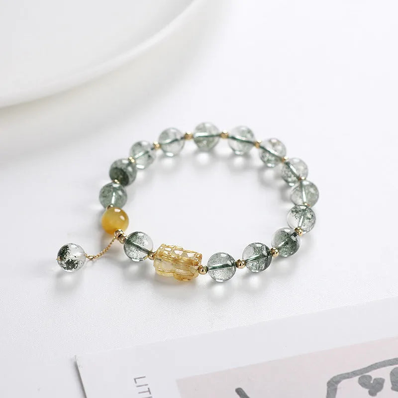 Green phantom quartz bracelet with gold rutile inclusions and geometric ethnic design