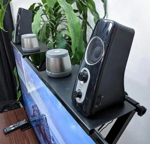 Black adjustable screen top shelf, 13-inch wide, mounted on TV, holding streaming device and remote
