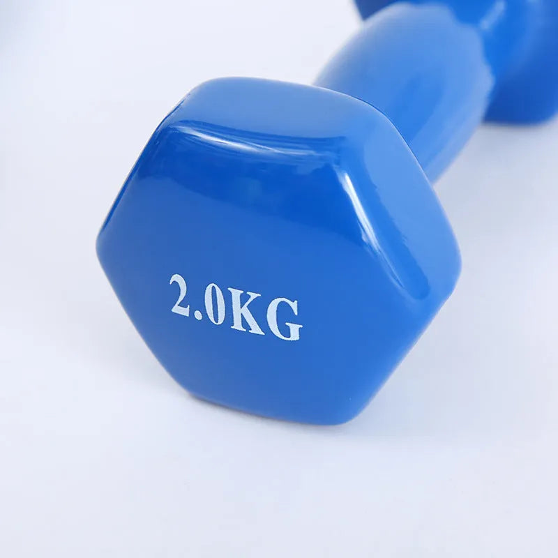 Brightly coloured plastic fitness dumbbells on a floor, showing glossy surface and multiple weight options.