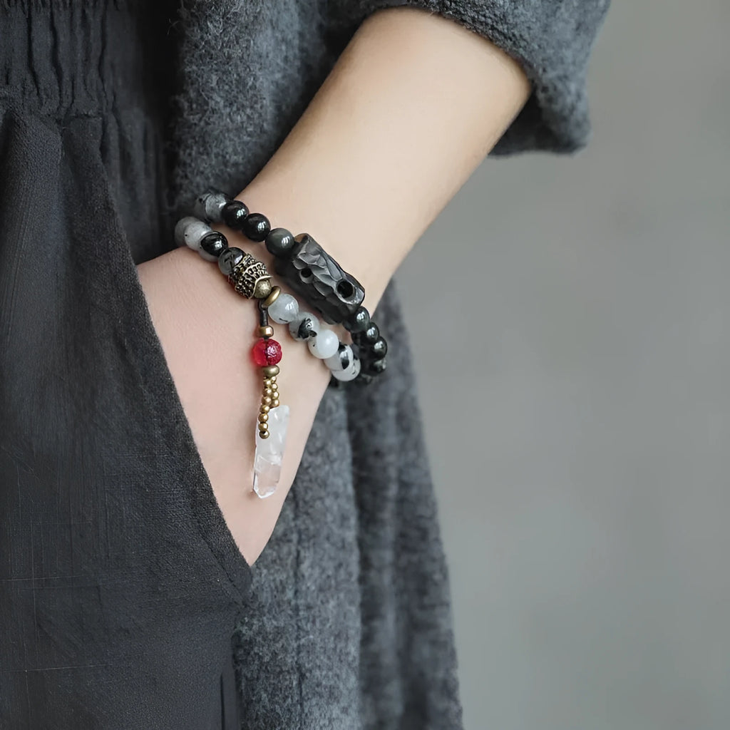 Ethnic style black hair crystal bracelet with white crystal tassel showing lacing construction
