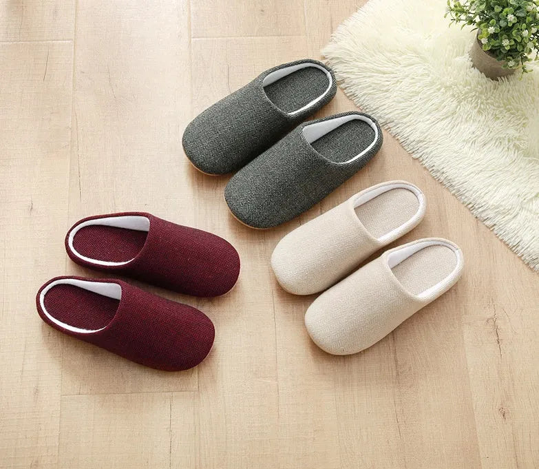 Men's cotton black indoor slippers with anti-skid sole on a home floor