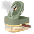 Pearl white USB desktop humidifier mist fan with water tank, remote control, and night light on a wooden desk.