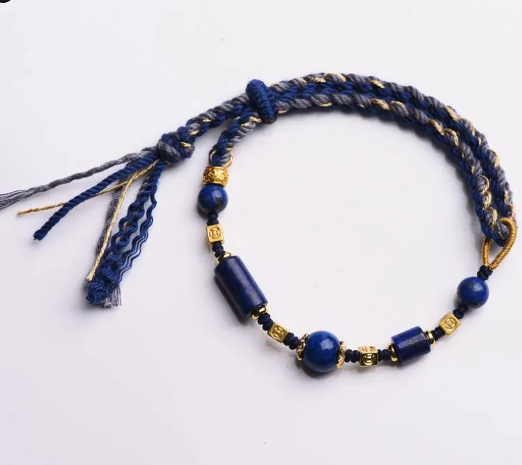 Close-up of a hand-woven flexible wire bracelet for women with a Lapis Lazuli stone accent.