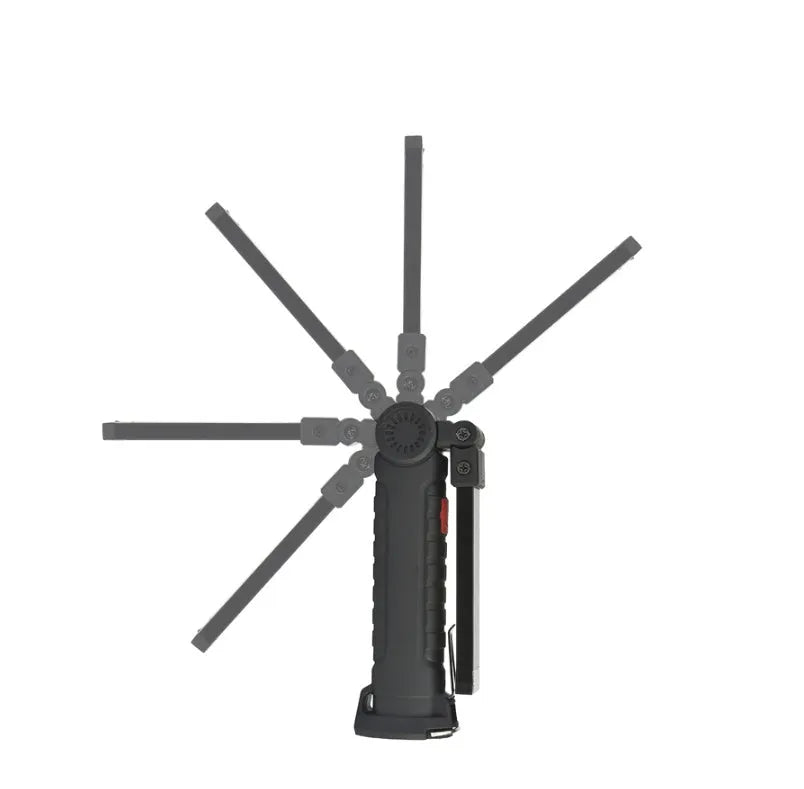 COB LED tactical flashlight in carbon-black finish with folding stand, magnet, and hanging hook on a metal surface