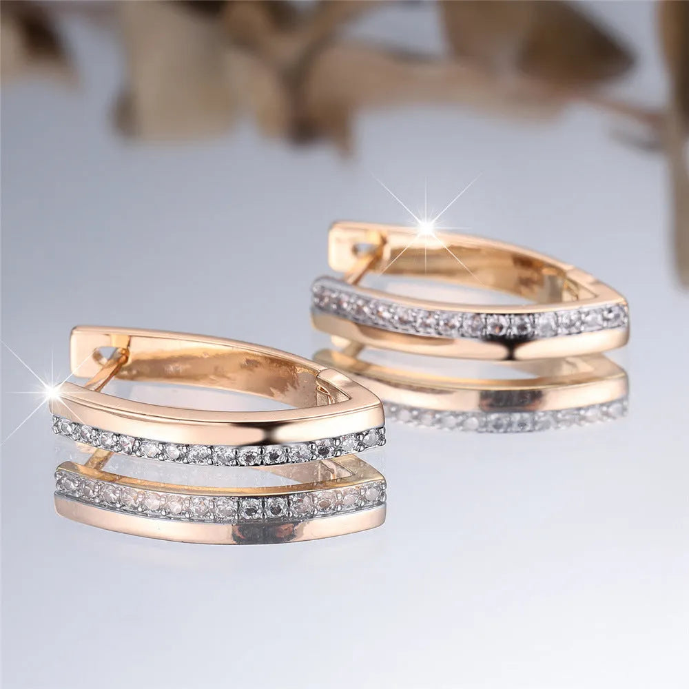 Close-up of women's geometric V-shaped champagne gold ear clips with a clip-on back.