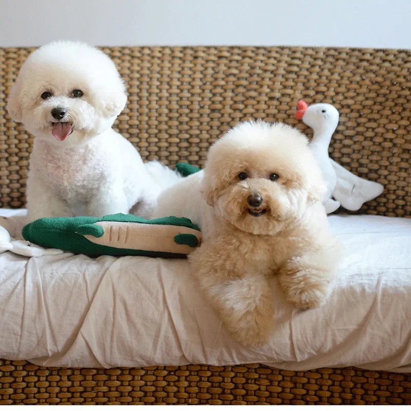 Green plush stuffed toy dog on white background, showing soft texture and size.