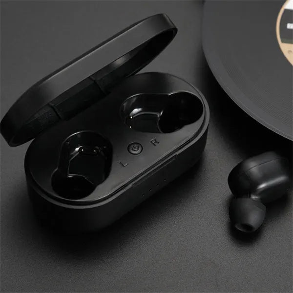 Black and white M1 wireless Bluetooth earbuds with a charging case on a table.