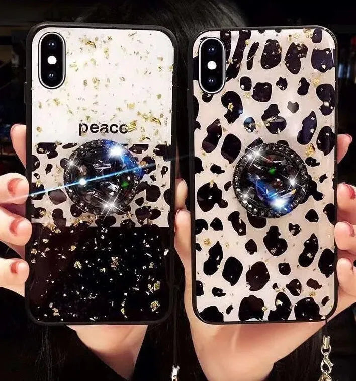 Leopard print pattern TPU back cover case for a mobile phone on a table.