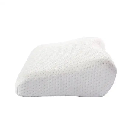 Blue butterfly-shaped memory foam cervical pillow on a bed.