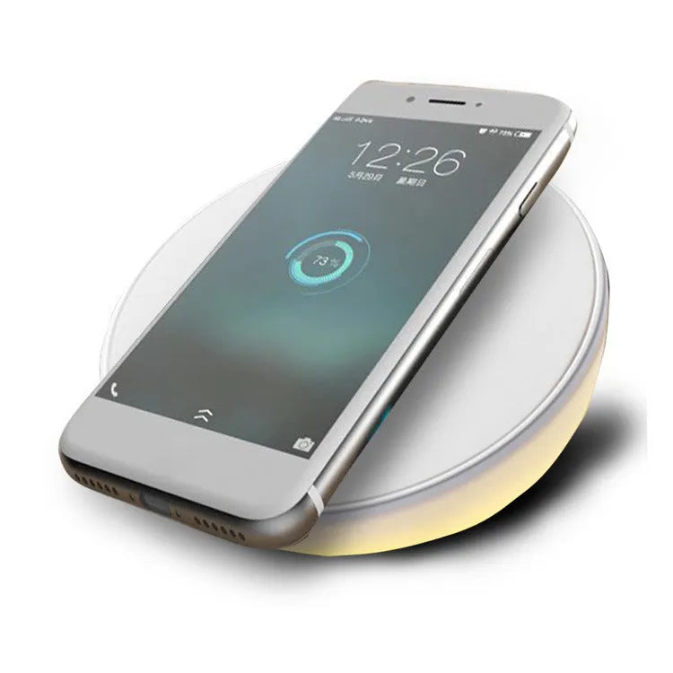 White wireless charger with clock display and three control buttons for mobile phone charging