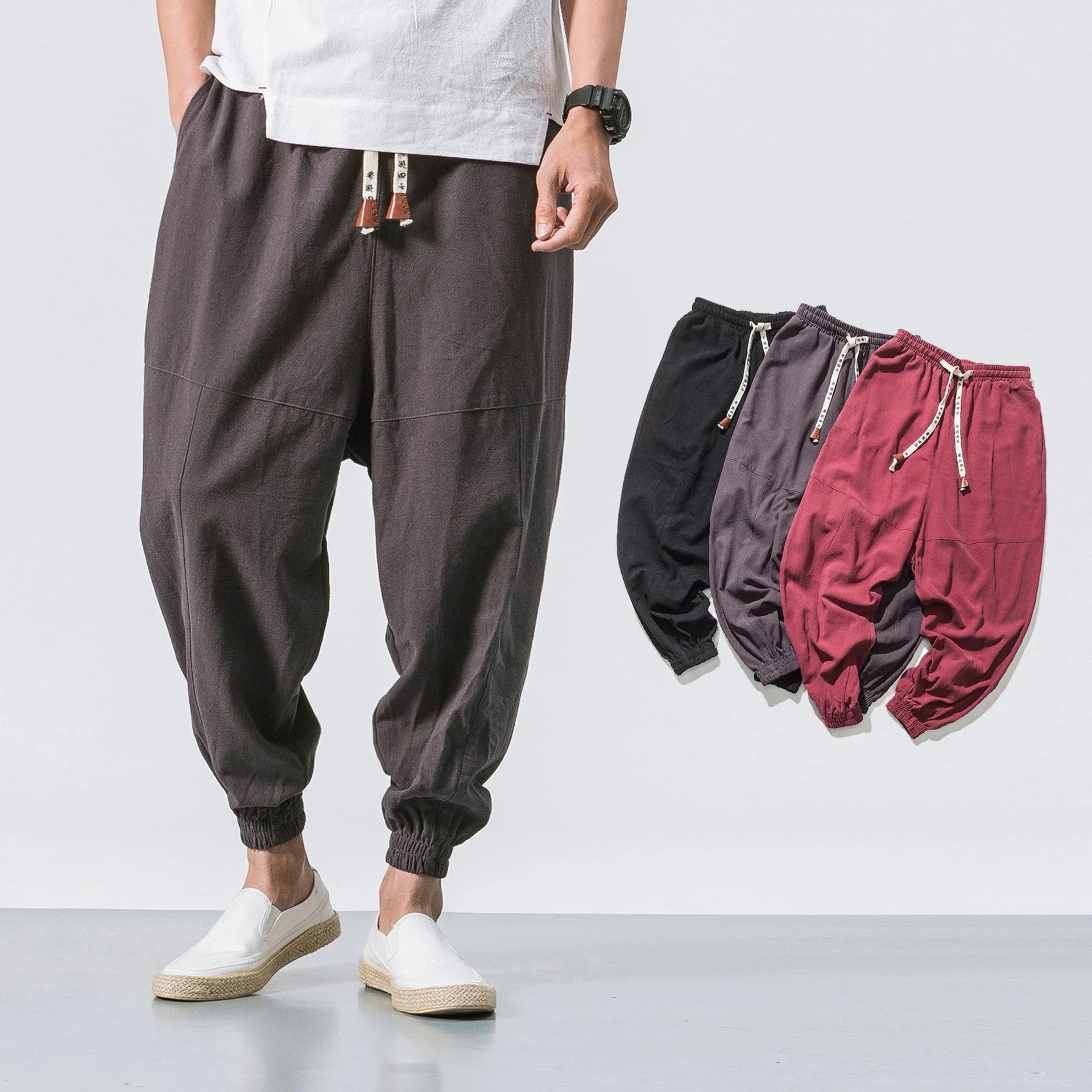 Men's cotton jogger pants with drawstring waist, side pockets, and tapered legs in various colors