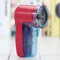 Portable electric lint remover with compact handheld design measuring 11cm for removing clothing pills