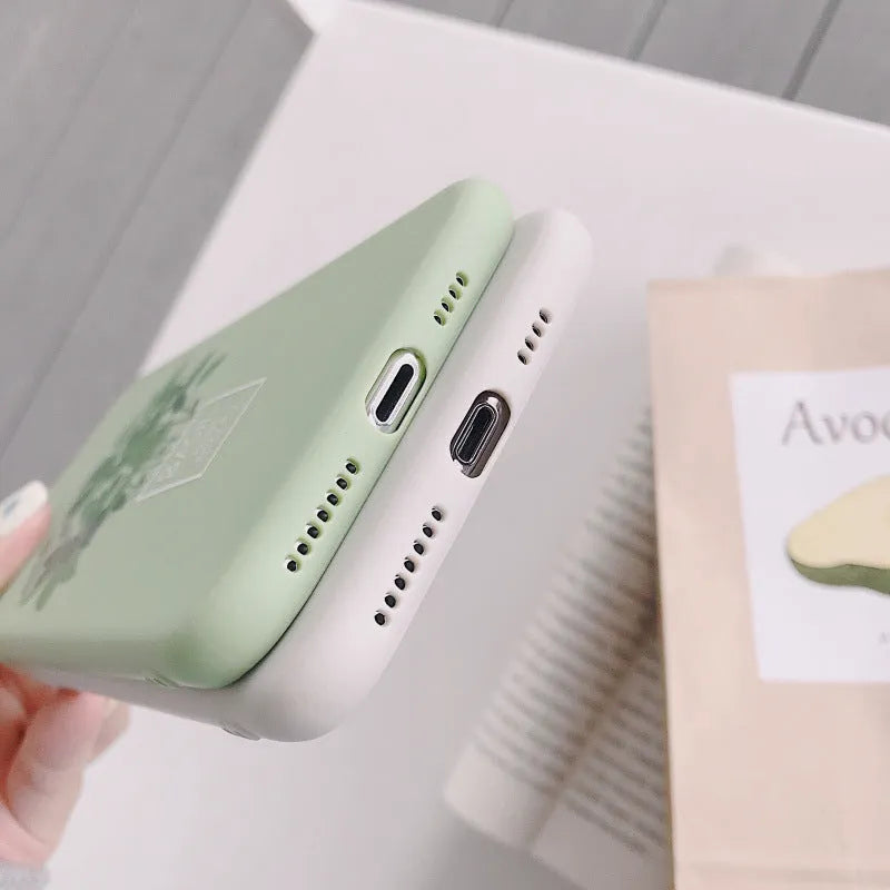 White silicone iPhone case with a detailed painted botanical plant design on the back.