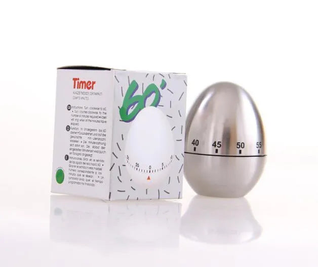 Stainless steel egg-shaped mechanical kitchen timer on a kitchen counter