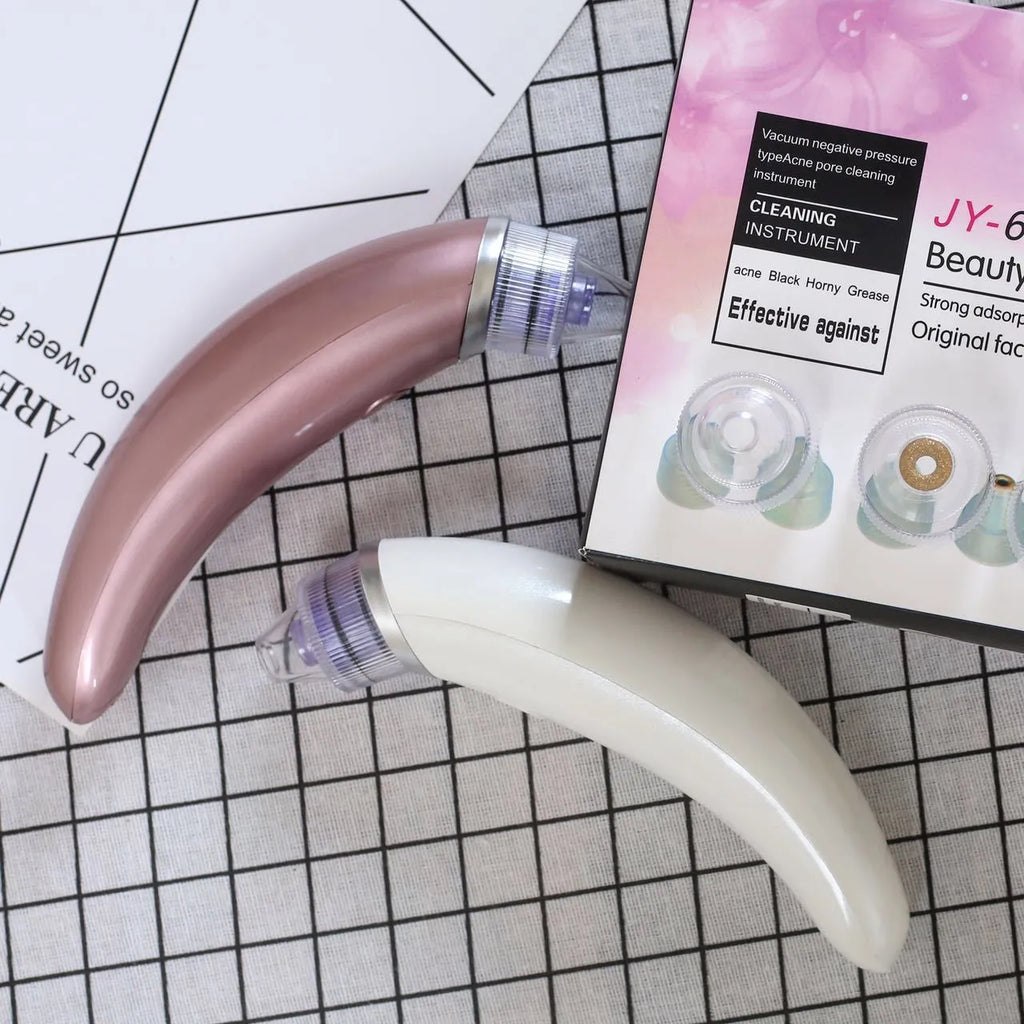 Rose gold and white electric blackhead suction instrument for facial pore cleaning.