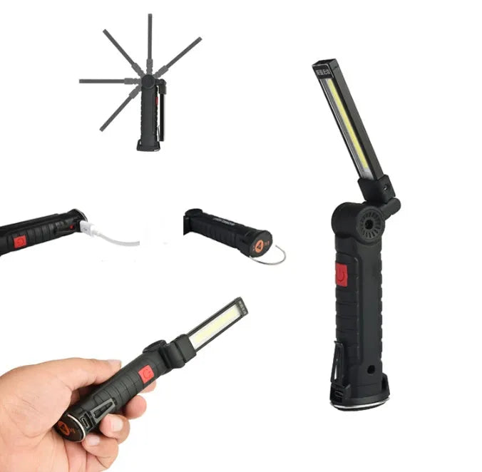 COB LED tactical flashlight in carbon-black finish with folding stand, magnet, and hanging hook on a metal surface