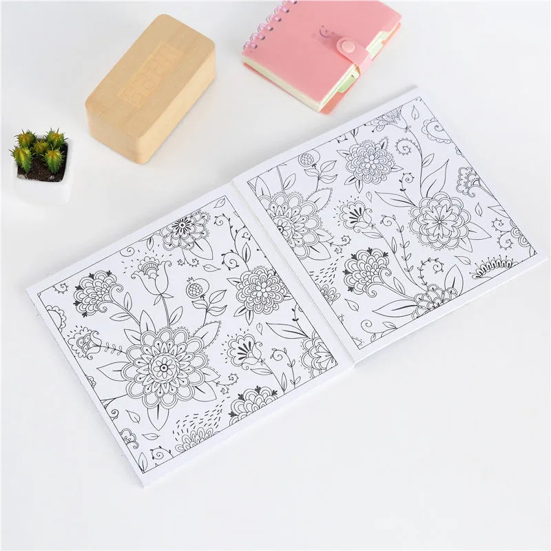 Square mandala colouring book open to show geometric patterns, with soft binder cover.