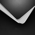 Black aluminium alloy double-sided mouse pad with wrist guard on desk