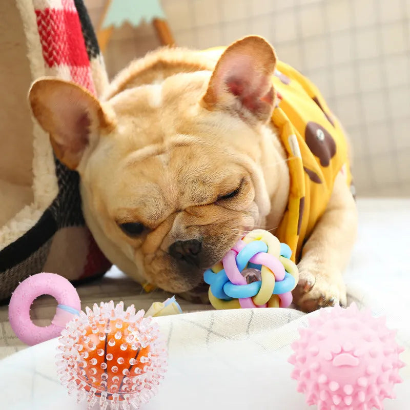 Non-toxic rubber dog chew toy with surface particles, star ring ball shapes, pink blue yellow