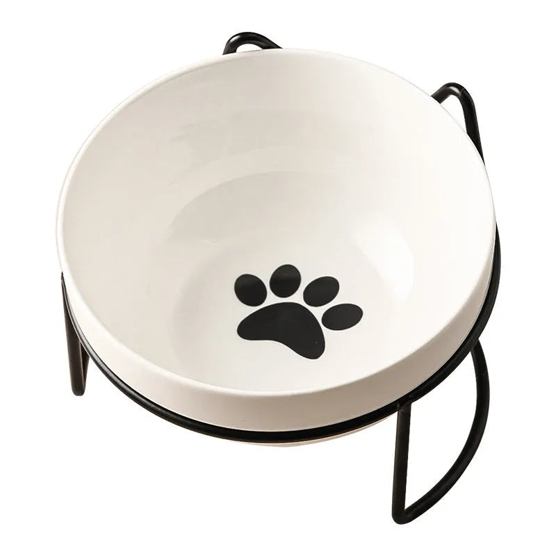 White ceramic cat bowl with cat paw design on a black iron stand