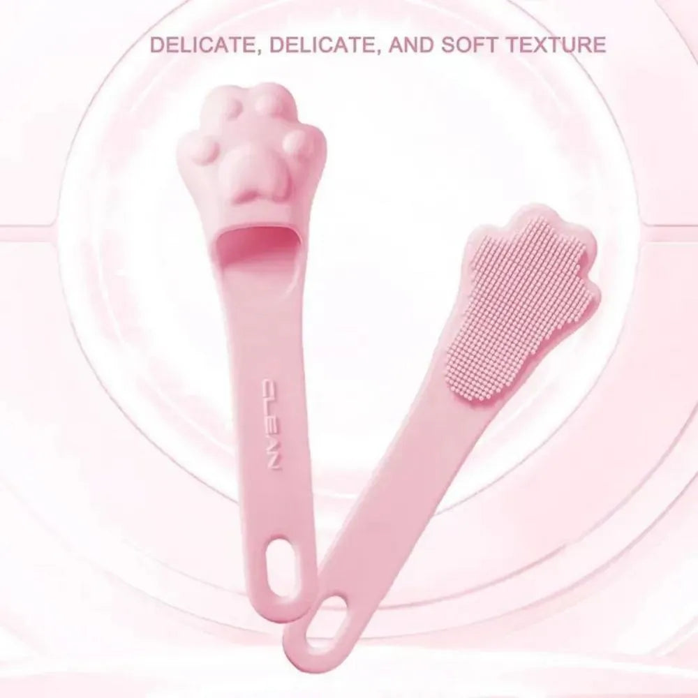 Silicone fingertip toothbrush for pets in pink, purple, and yellow, shown on a finger.