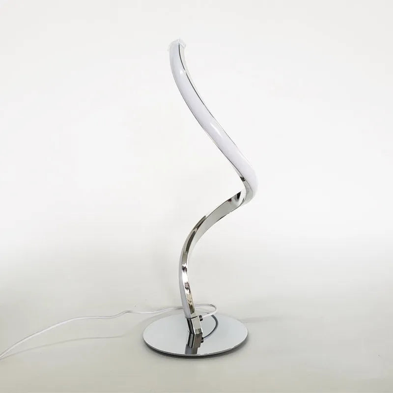 Advanced touch dimming desk lamp in white with white light mode on a bedside table