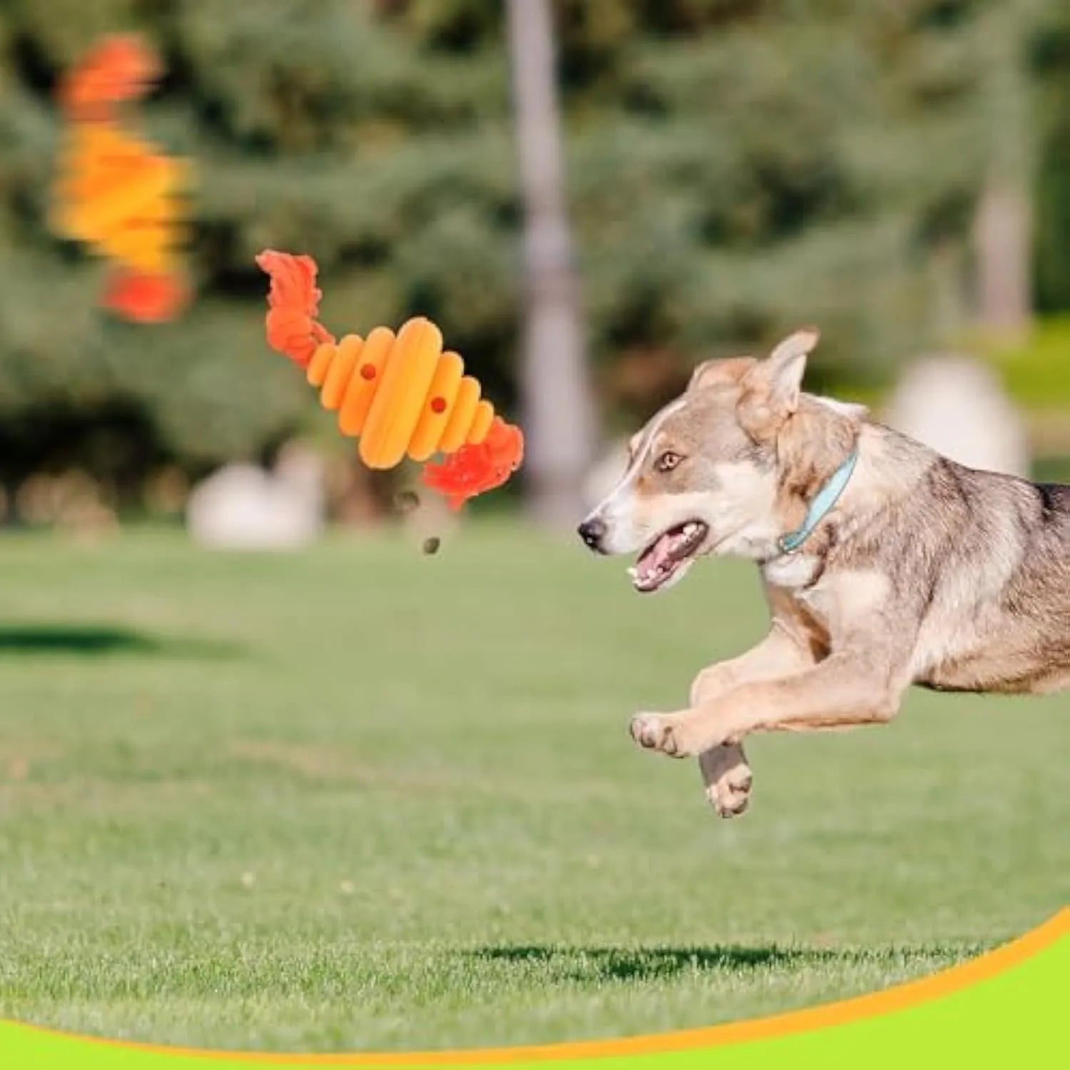 Green and yellow silicone dog ball with integrated rope, shown as a treat-dispensing and tug toy.