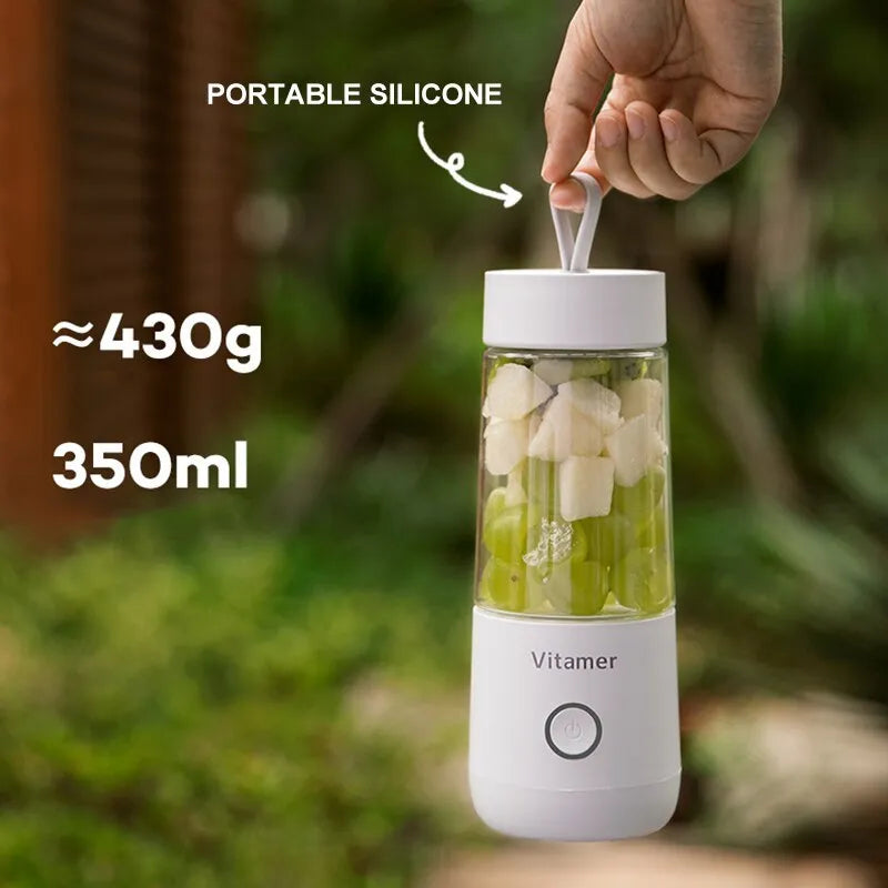White portable USB blender bottle with silicone handle and stainless steel blade inside.