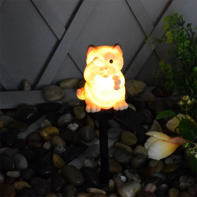 Brown resin cat-shaped solar garden light for outdoor decorative lighting.