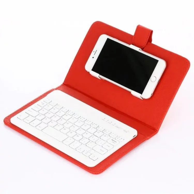 A black wireless Bluetooth keyboard next to its protective holster case, compatible with all phones and tablets.