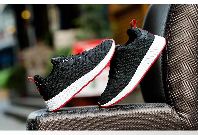 Men Malcolm Sneaker in black from side view showing mesh fabric upper and low-top design