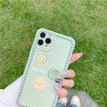 Green soft TPU iPhone case with geometric smiley face and polka dot frame design.
