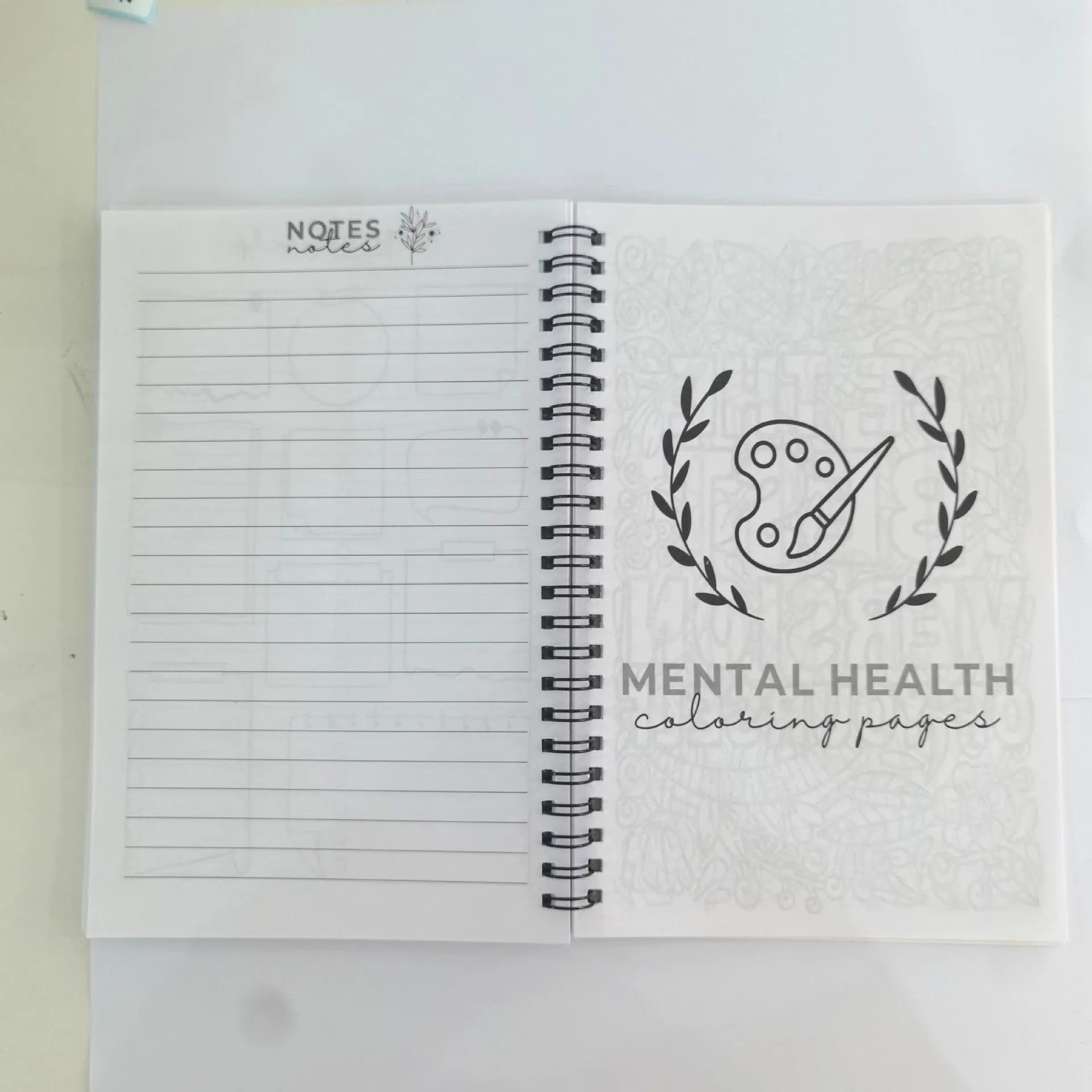 Pink paper cover coil-bound brain mental health notebook with 80g pages, open to blank pages