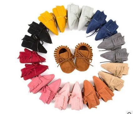 Baby tassel shoes in PU and flock with soft bottom, shown in one of eleven colours and sizes 11cm to 13cm
