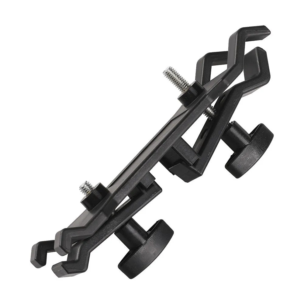 Black ABS umbrella clip attached to camera tripod shaft with umbrella in mounting position